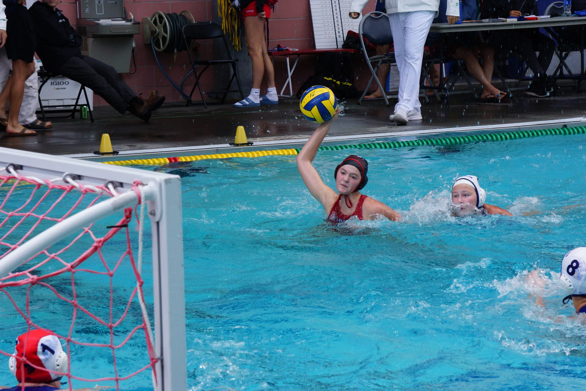 A player holds the ball up in front of the goal