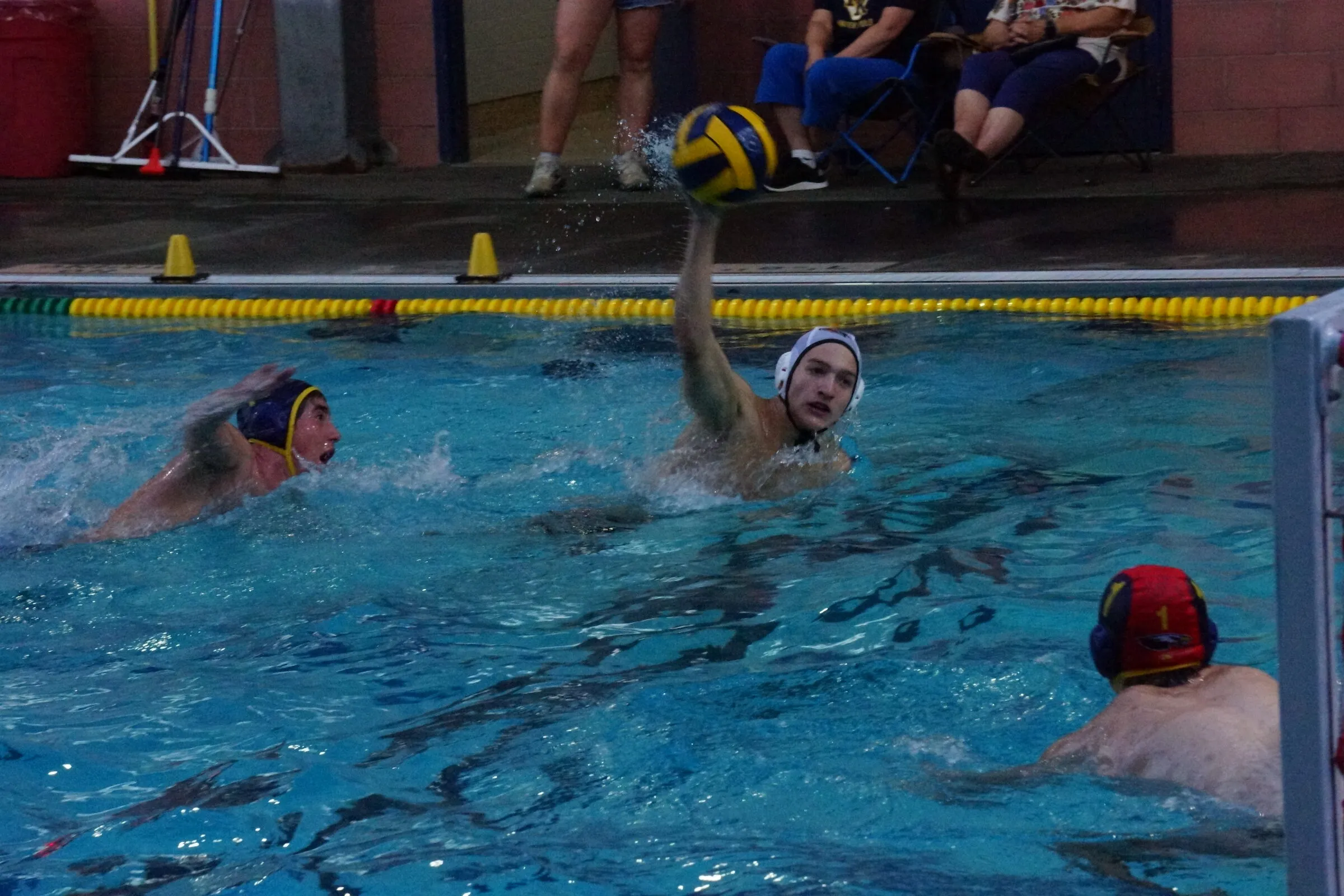 A player reaches for a high pass